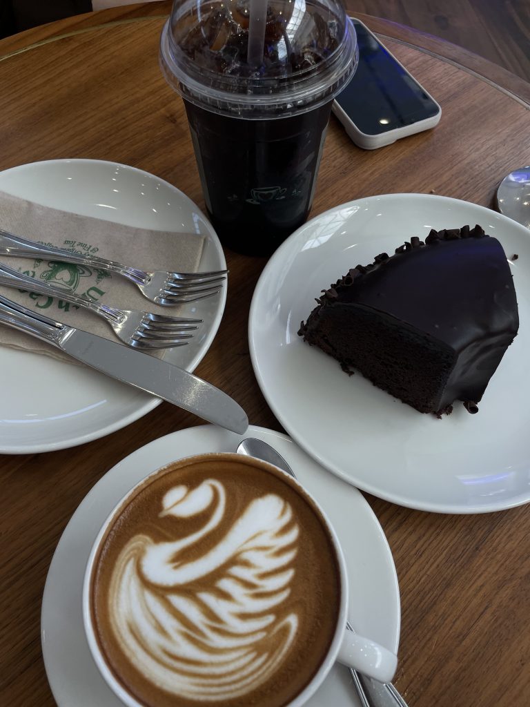 a slice of chocolate cake and a cup of coffee in a coffee shop in Riyadh, Saudi Arabia