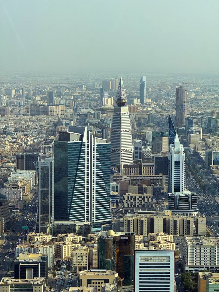 Aerial view of Riyadh's skyline featuring modern skyscrapers on a clear day.